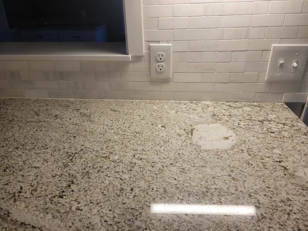 Close view of a tiled backsplash and patterned countertop