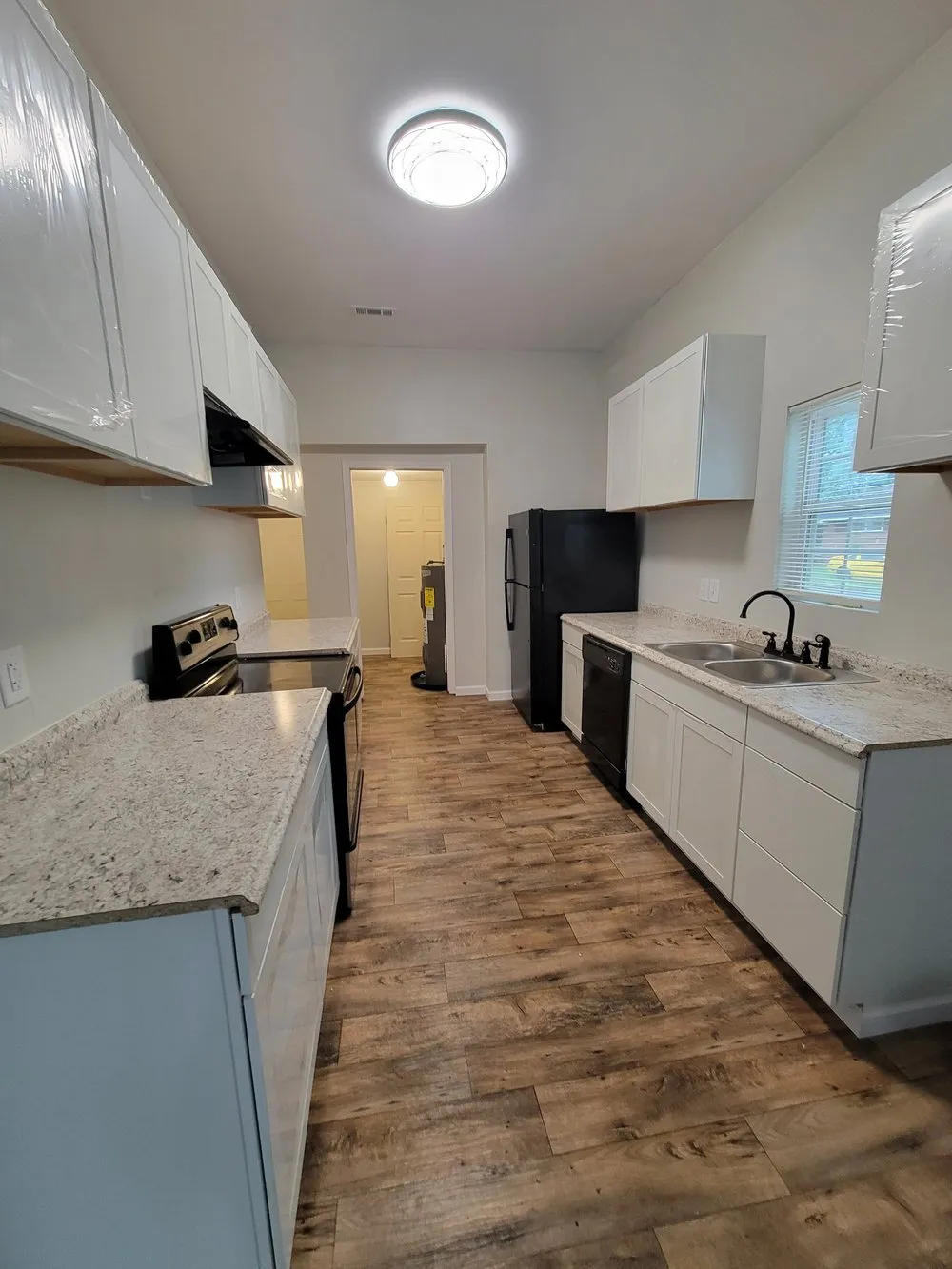 White galley kitchen with stainless steel appliances